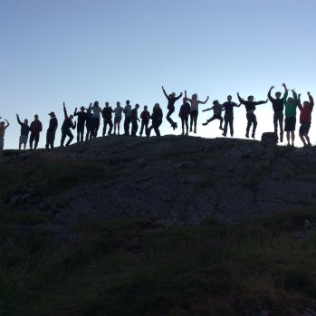 a phot of scouts standing on a hill top in silhouette 