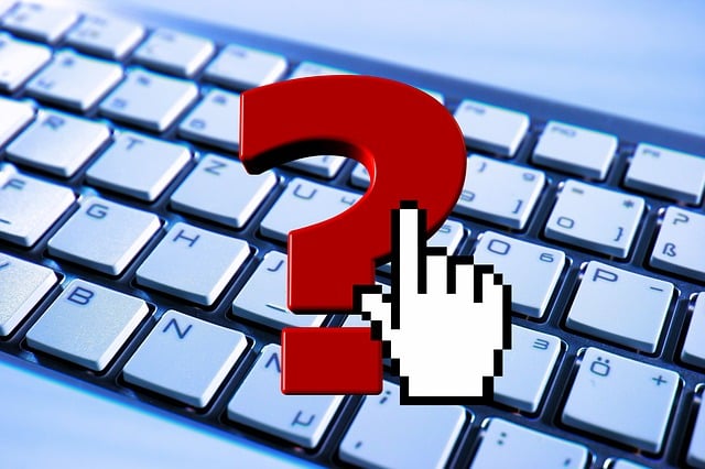a photo of a computer keyboard with a red question mark superimposed over the top 