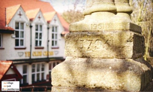 Picture of Ye Olde Cross Pub and stone cross in foreground