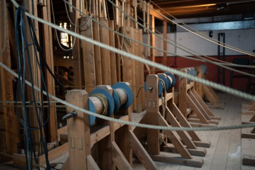 A section of wooden machinery with ropes and winches