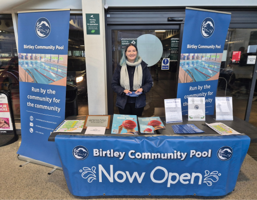 Volunteering at a stall handing out leaflets and collecting donations
