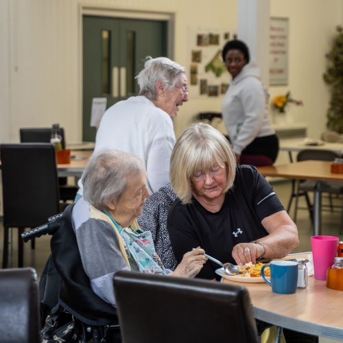 lady helping and elderly at the Musical cafe