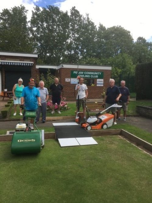a photo of members of the gardening group standing outside the bowling club.