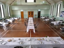 hall laid out with tables for a celebration
