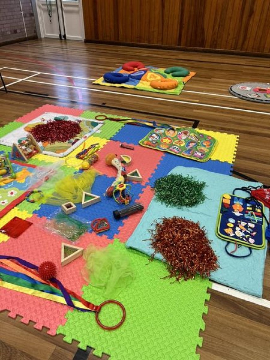 Brightly coloured image showing various toys on a playmat