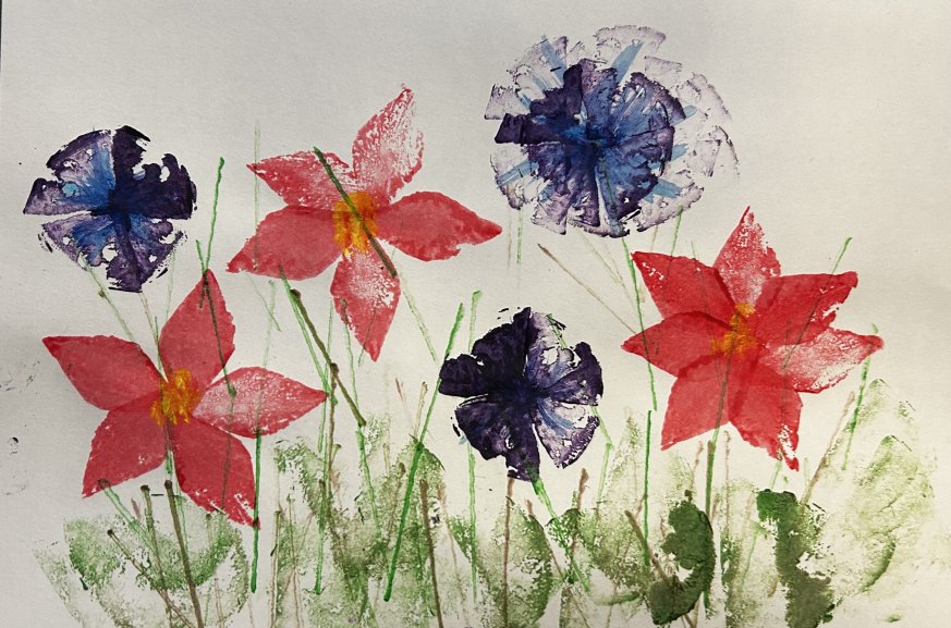 A painting of pink and blue flowers made from potato prints.