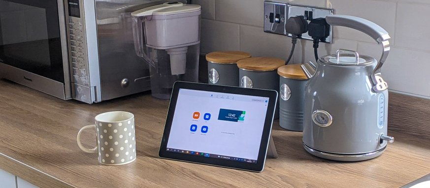 Picture of Zoom app open on a screen by a kettle and mug.