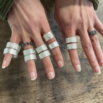 Hands displaying Silver Rings made in a Workshop