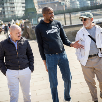 Photograph of three male caregivers walking and talking