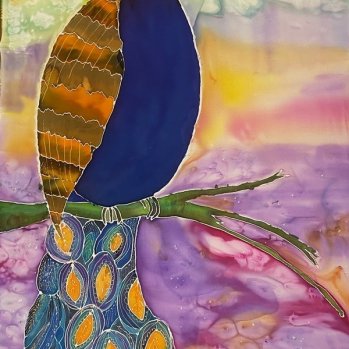 A peacock painted in blue and orange/gold, sitting on a green branch with muted colours of pink, purple, yellow, green and blue as as sky merging into a sunset and landscape