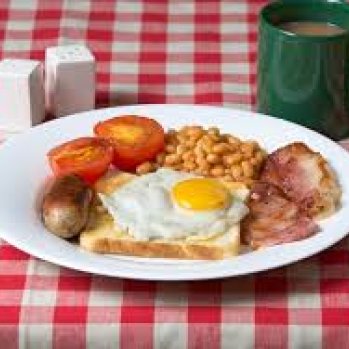 photo of a cooked breakfast on a red and white checked tablecloth