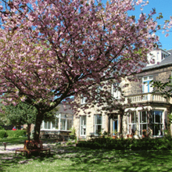 Photo of the Community centre with a tree in blossom in the forground