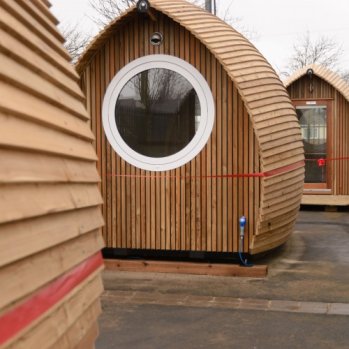 photo of the little wooden pods that can be hired to allow people to work locally