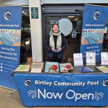 Volunteering at a stall handing out leaflets and collecting donations