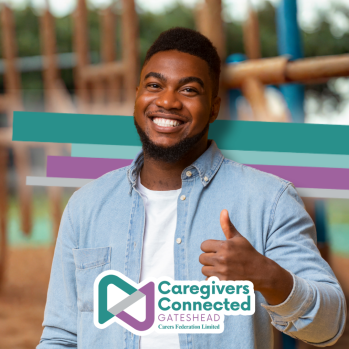 Photograph of a man giving a thumbs up.