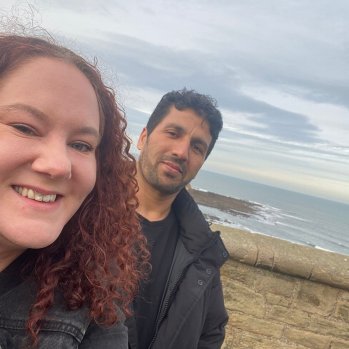 Photo of a befriender and refugee friend visiting the beach together