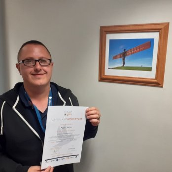 Paul holding his certificate