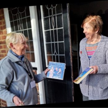 Reader being greeted with a book on their doorstep