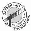 The Gateshead FC Badge - a football by the feet of the Angel of the North, encircled by a banner with the name of the club. 'Foundation' added outside the circle.